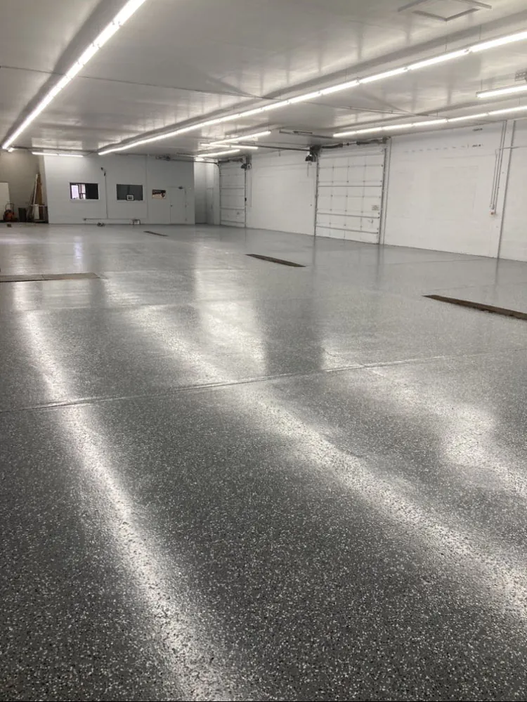 Flake epoxy floor in a commercial shop with overhead lighting