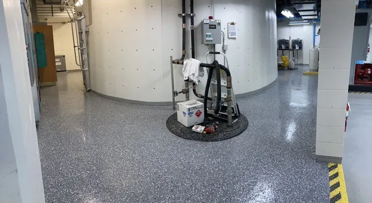 Flake epoxy floor in a mechanical room with safety striping