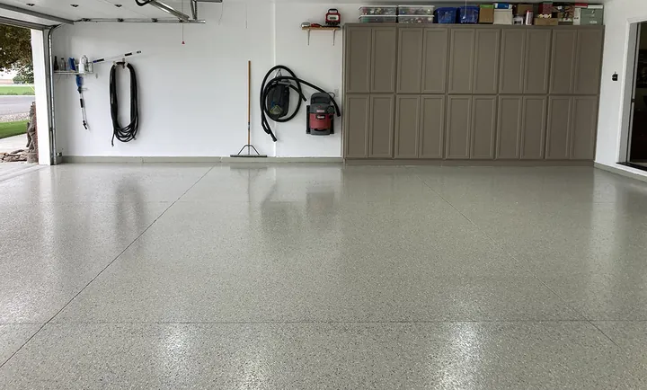 Garage with flake epoxy floor, cabinets and workbench