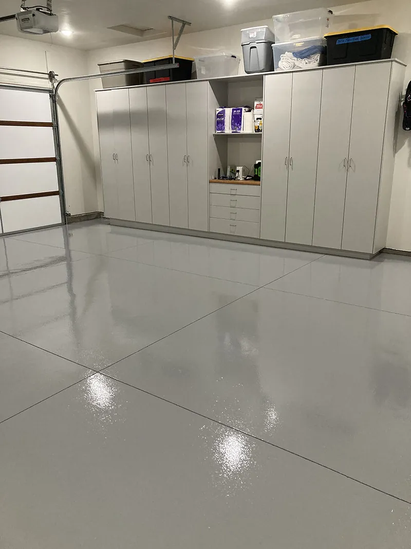 Solid gray epoxy garage floor with built-in cabinets