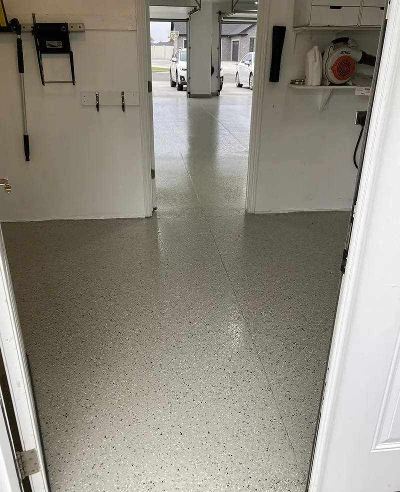 Flake epoxy garage floor with wall-mounted storage