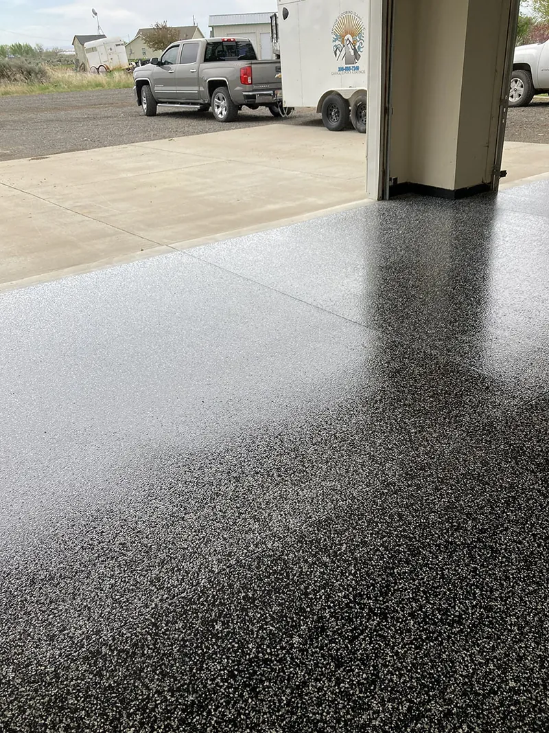 Flake epoxy garage floor with a truck in the driveway