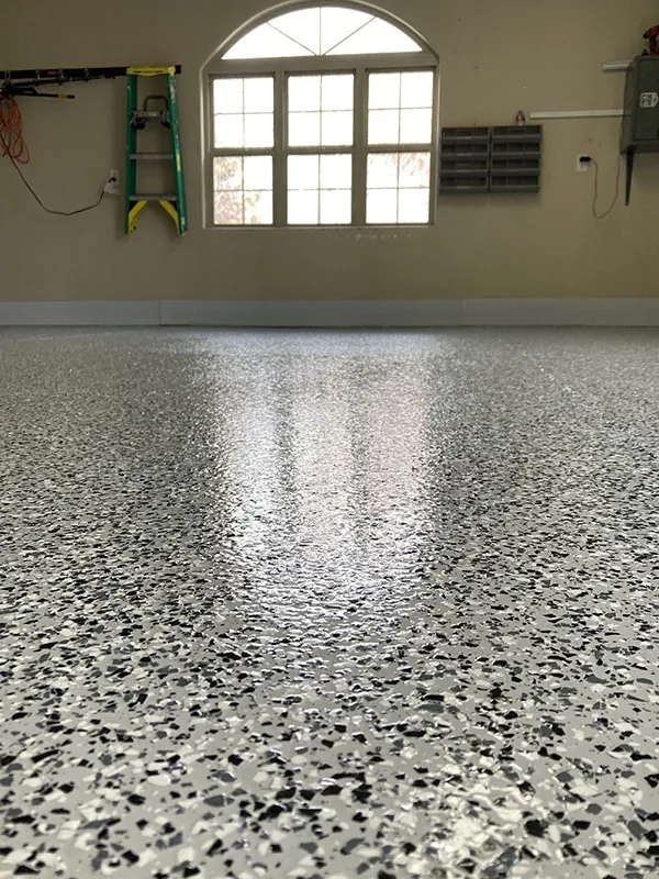 Flake epoxy garage floor by an arched window