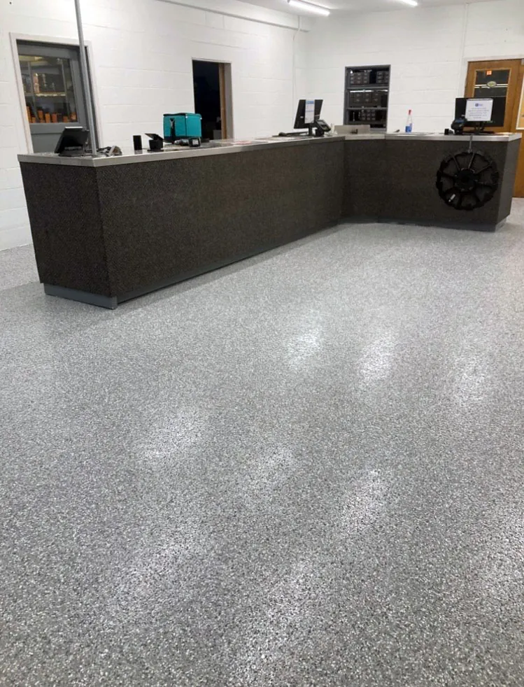 Flake epoxy floor across a commercial shop and office