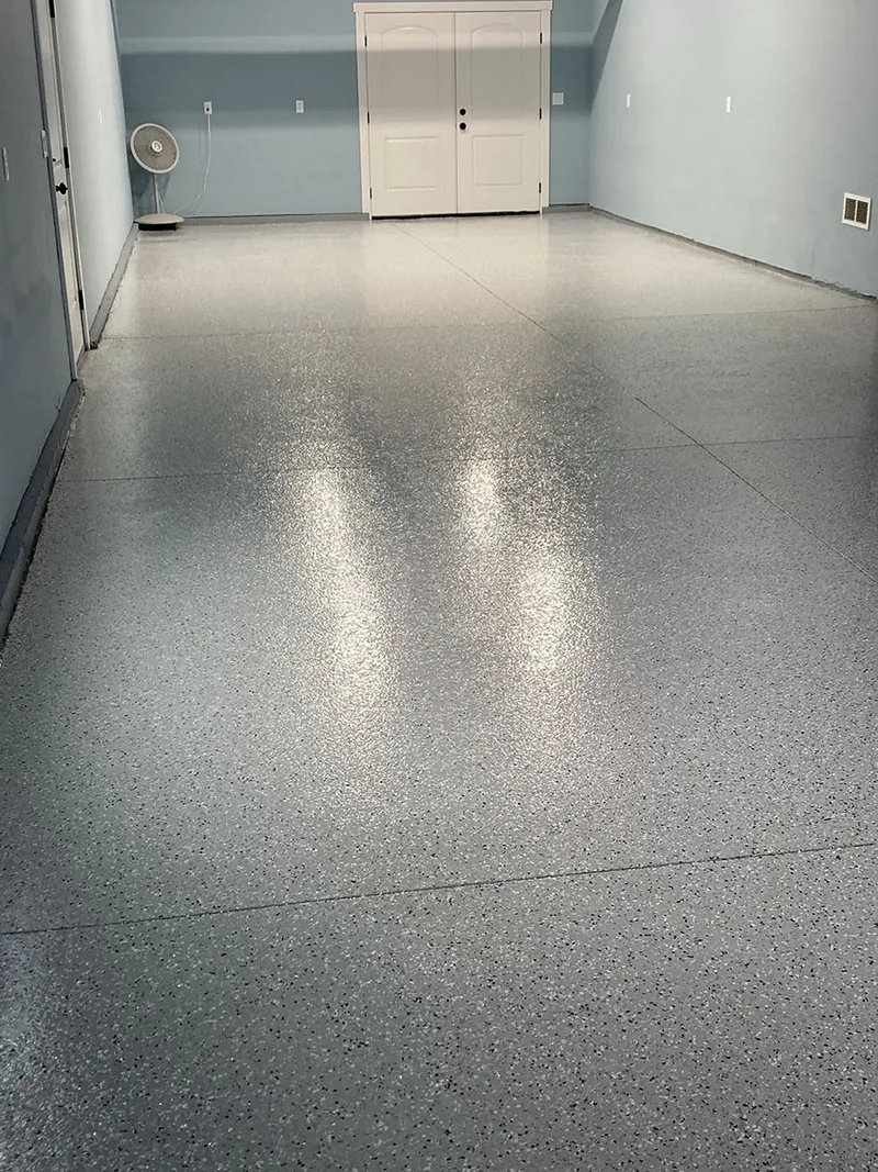 Gray flake epoxy garage floor with blue walls