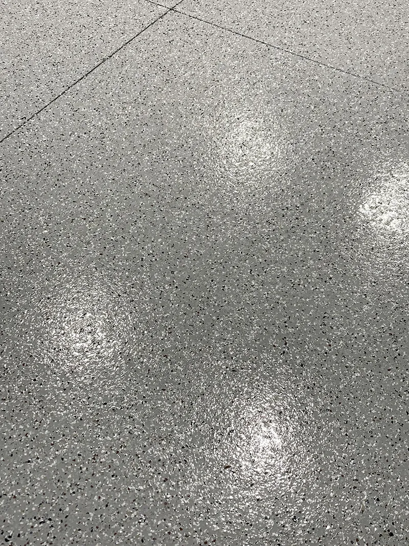 Flake epoxy floor detail with light reflections