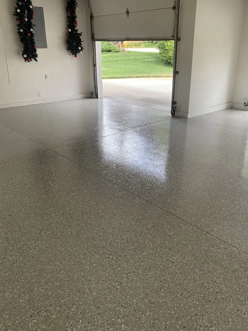 Flake epoxy garage floor with the door open to the driveway
