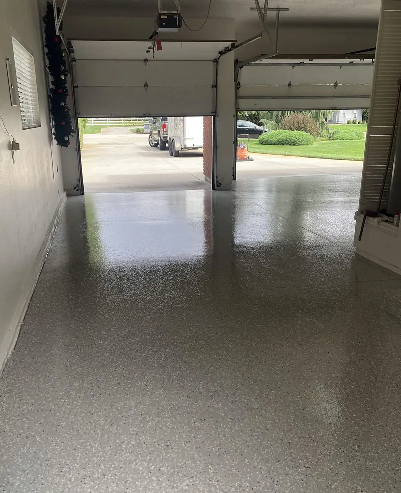 Two-car garage with flake epoxy floor, doors open