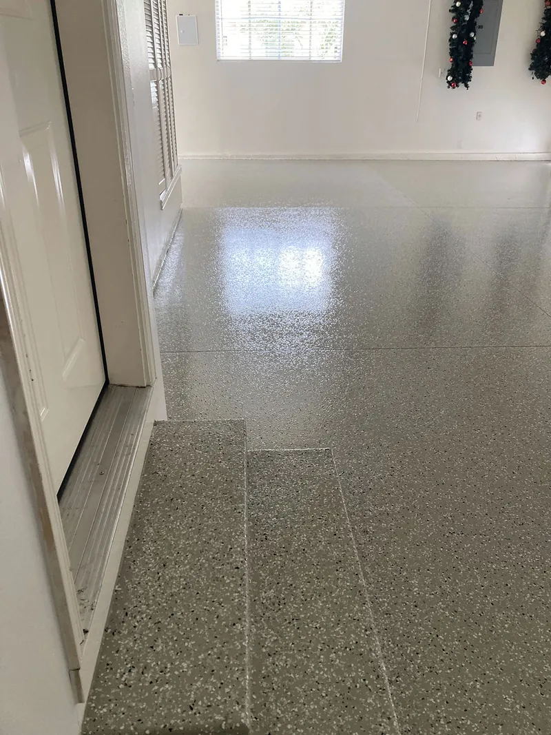 Flake epoxy garage floor with a window and side door