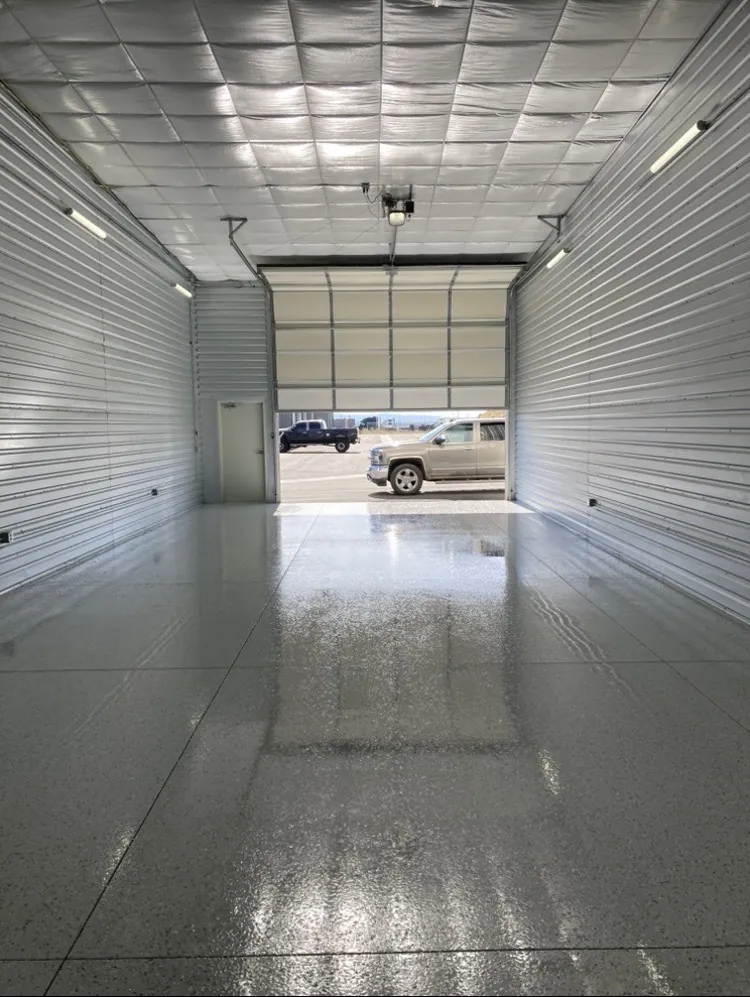 Solid gray epoxy floor in a storage and warehouse bay
