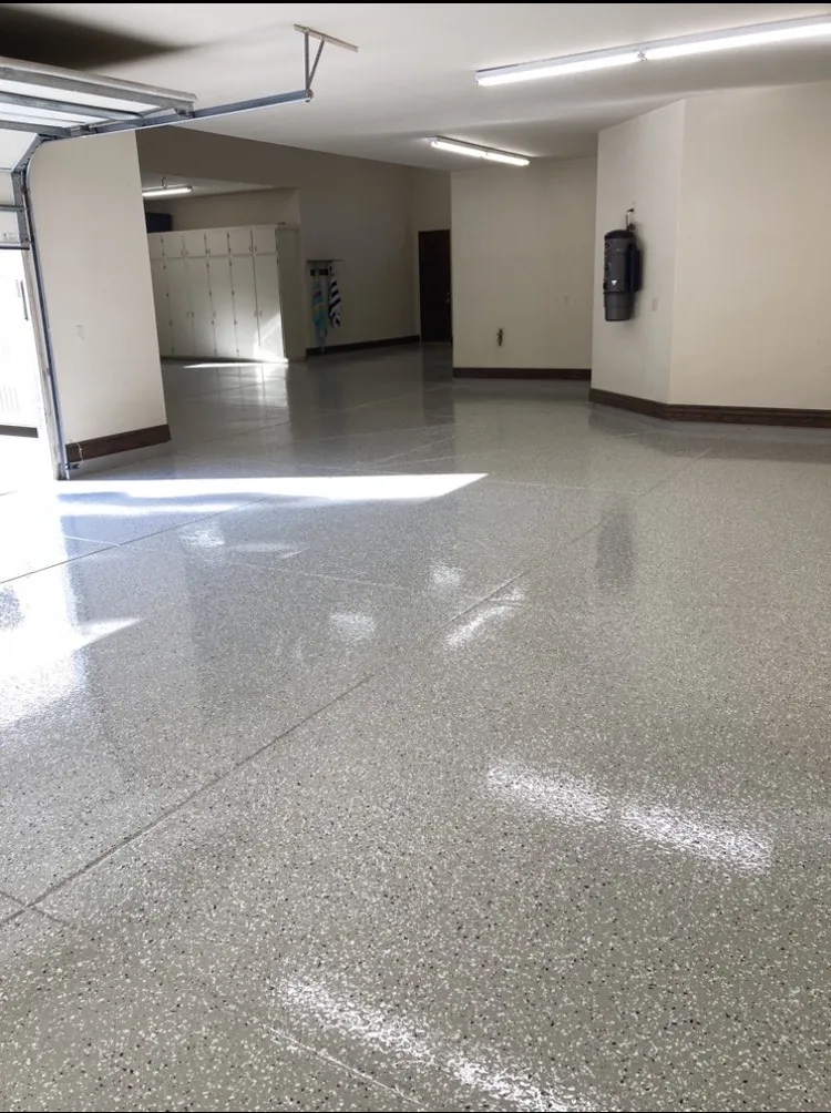 Solid gray epoxy floor in a commercial shop with lighting